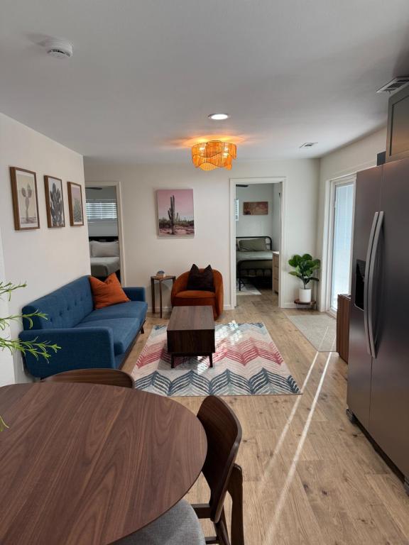 a living room with a blue couch and a table at Cute cottage in Sunrise Beach in Sunrise Beach