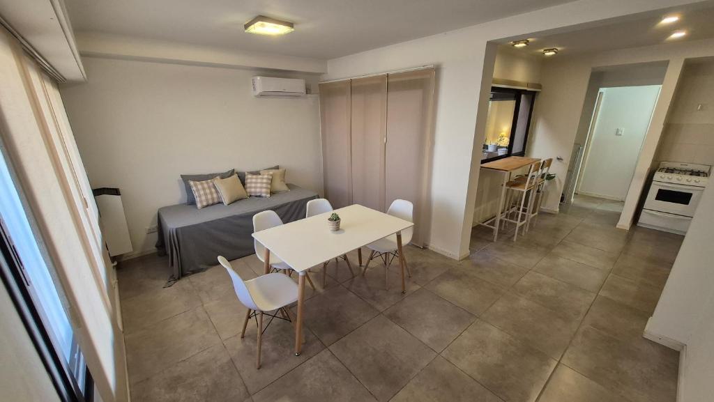 a living room with a bed and a table and chairs at La Escondida in Chascomús