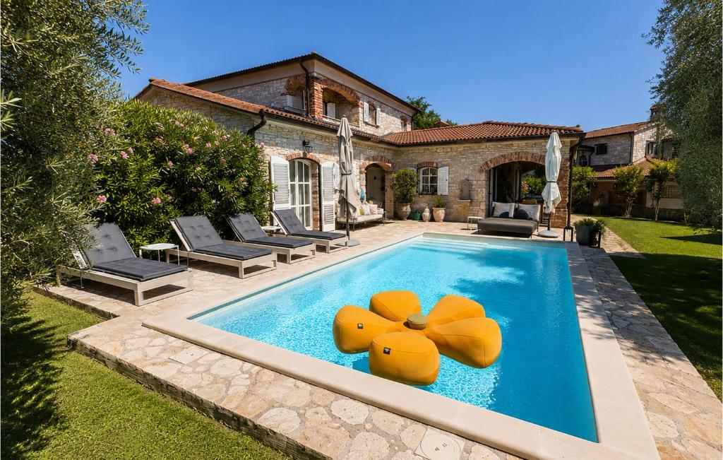 a swimming pool with a yellow bow on it at Villa Novel in Višnjan
