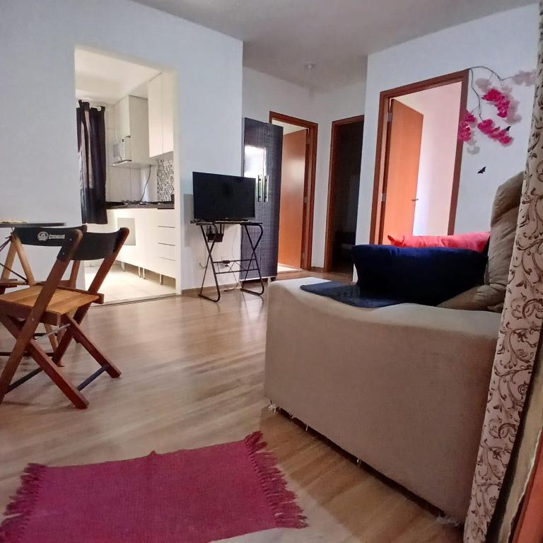 a living room with a couch and a table at Apartamento Harmonia! in Uberaba