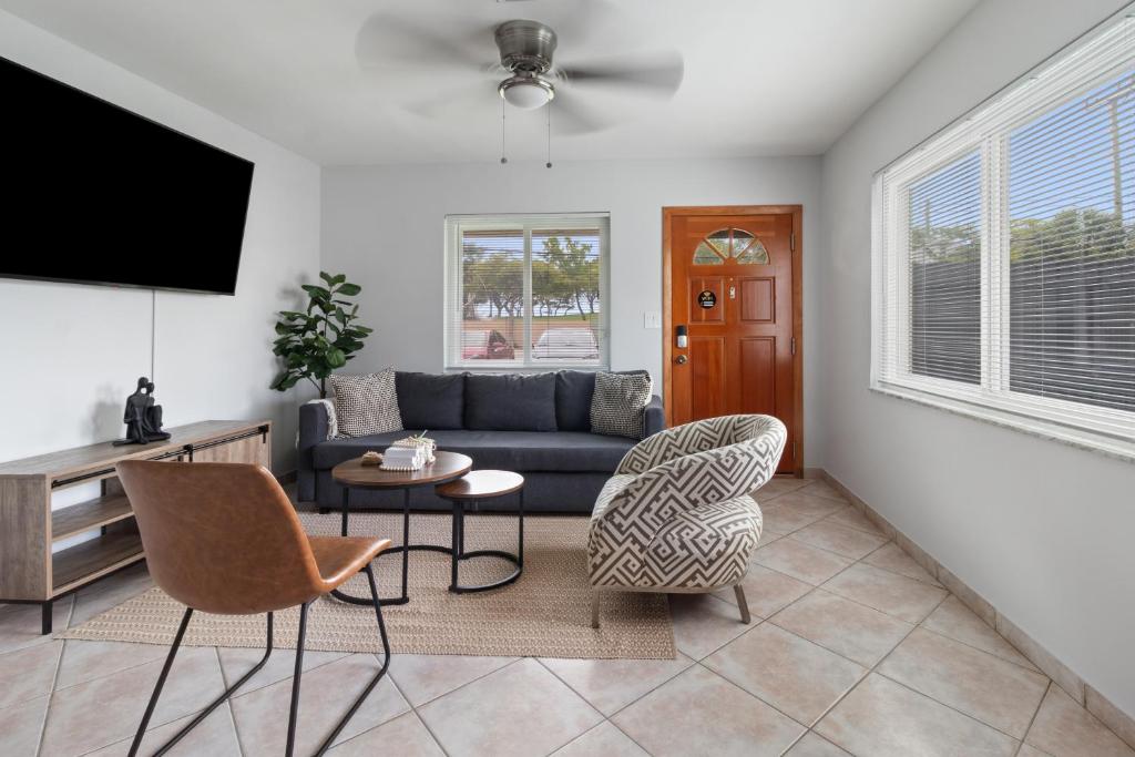 a living room with a couch and chairs and a tv at Stylish Dania Beach Stay Beach, Cruise Port FLL Airport in Dania Beach
