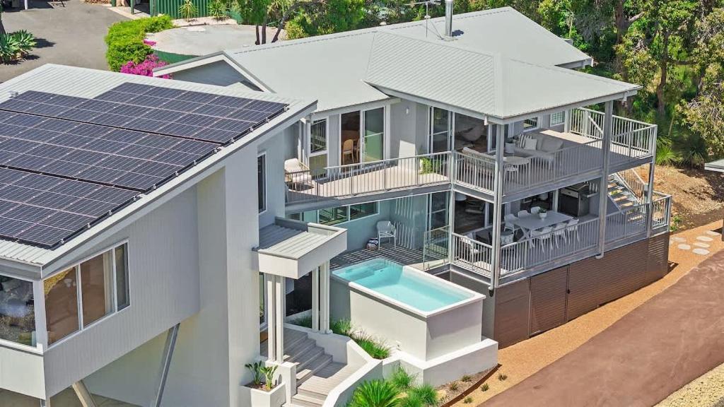 an aerial view of a house with solar panels on the roof at Eagle Heights - Elevated Oasis with Pool & Sea Views in Dunsborough