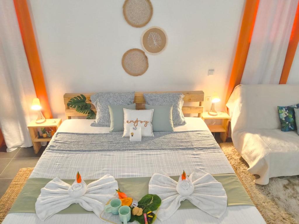 a bedroom with two beds with flowers on them at Terakota lodge in Deshaies