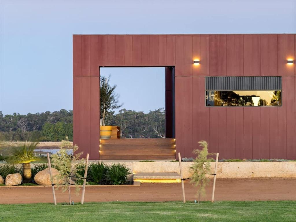 a building with a large window on the side of it at Samphire Chalet Tuart - Luxury Amidst Nature in Geographe