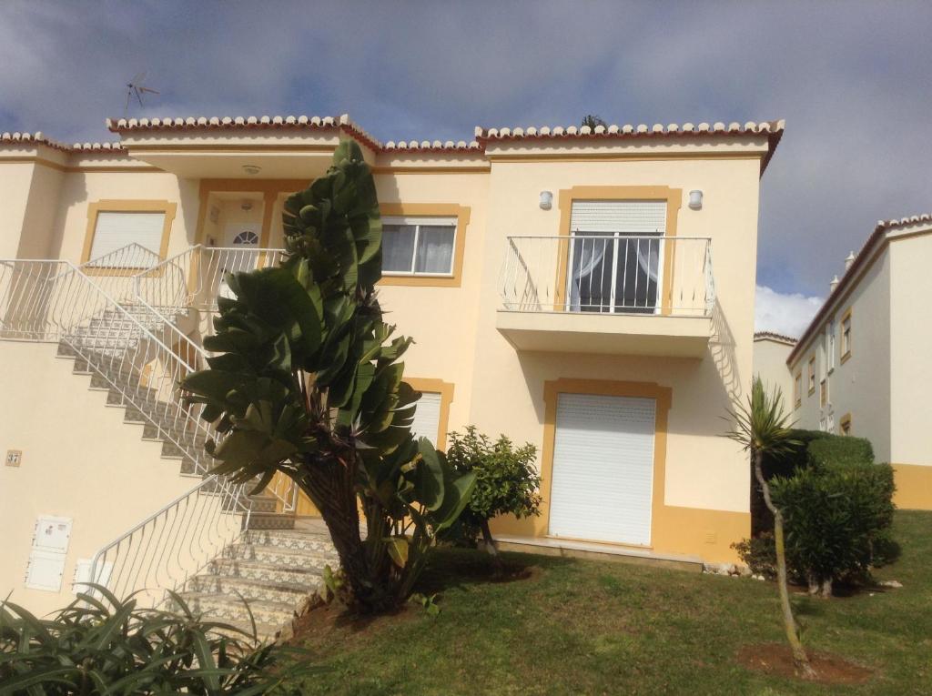 a villa with a staircase in front of a house at Votre appartement a Portimao in Portimão