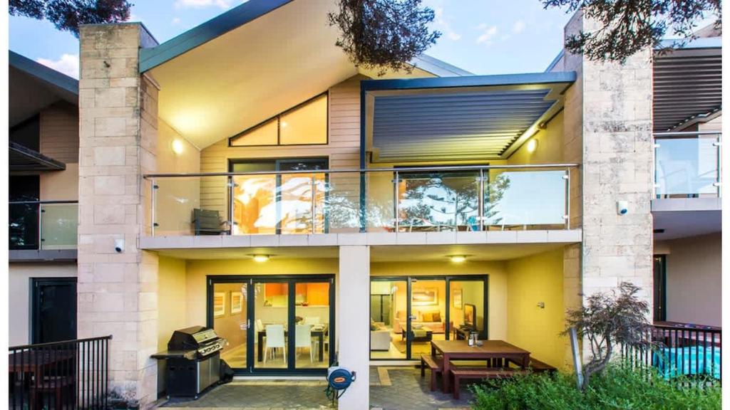 a house with a yellow facade with a balcony at Surfside 9 - In the Idyllic Yallingup Beach Scene in Yallingup