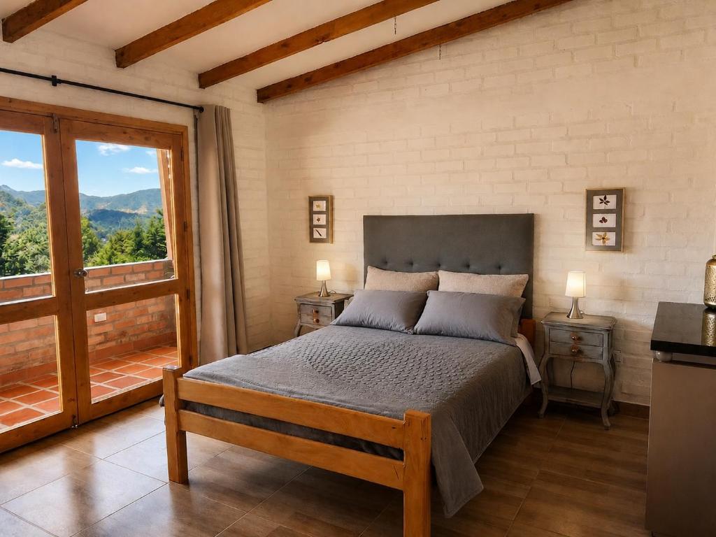 a bedroom with a bed and a large window at Villa Luz Hotel in Silvia