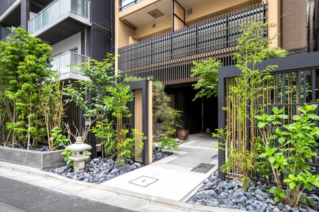 a garden in front of a building with plants at Morikoya Hotel in Tokyo