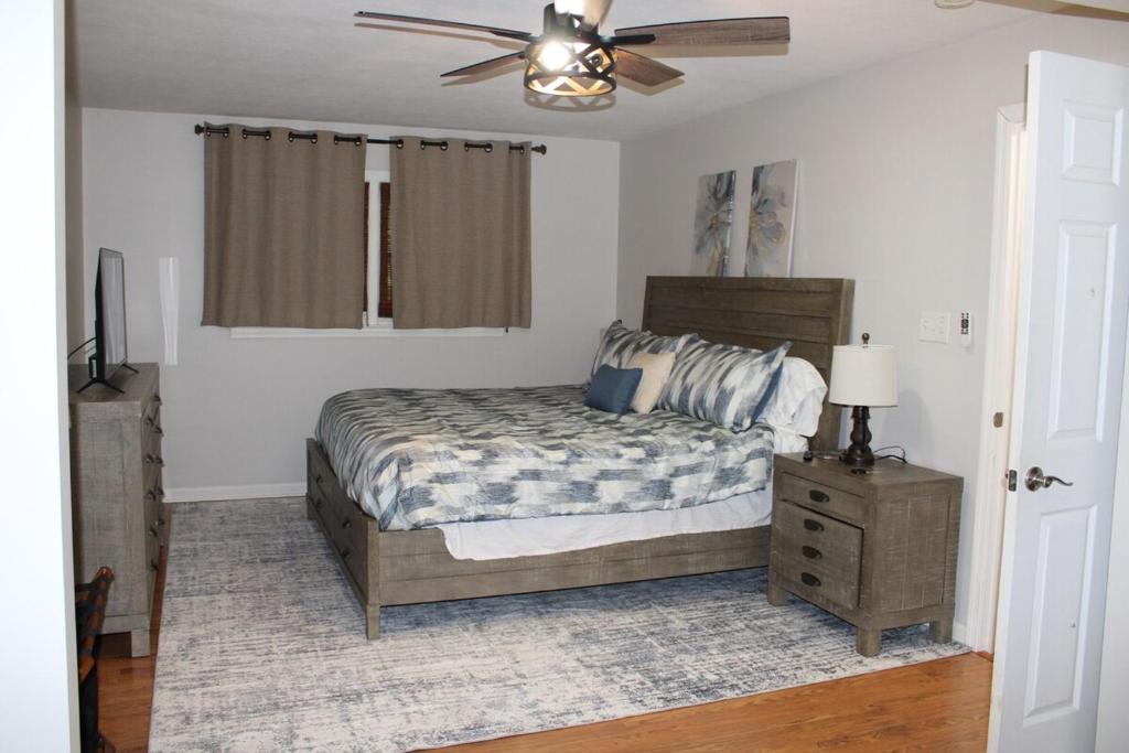 a bedroom with a bed and a ceiling fan at The Audobon Escape in Aiken