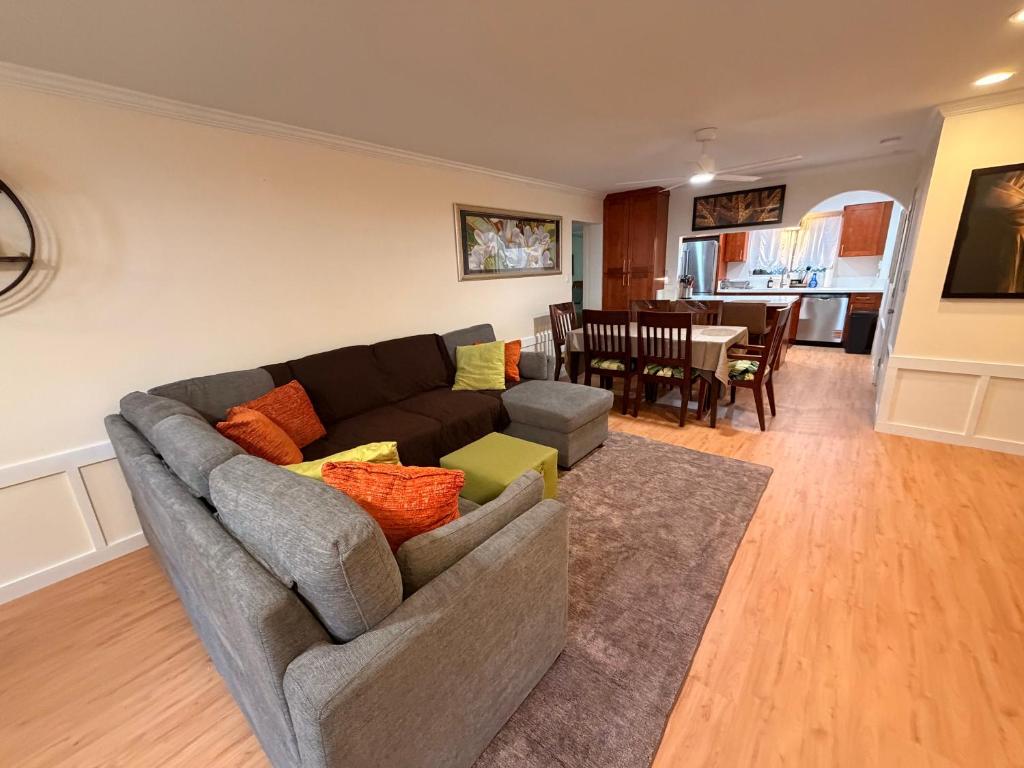 a living room with a couch and a dining room at Laie Temple Hale in Laie