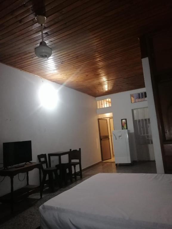 a bedroom with a bed and a table and a desk at Aparta Studio Las Palmas in La Dorada