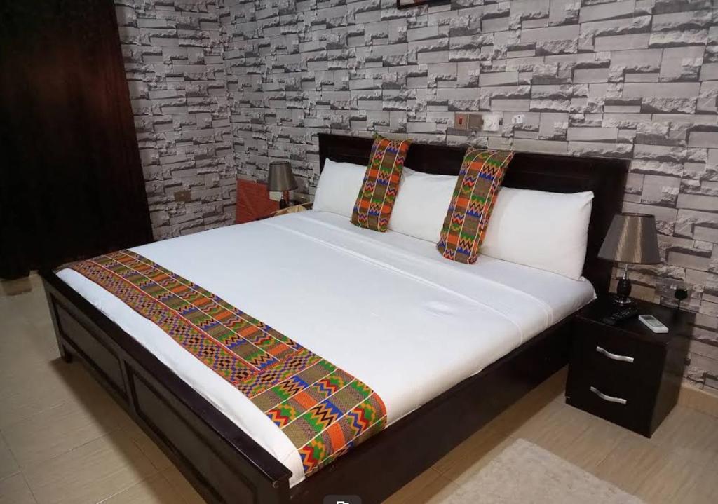 a bed with two pillows on it in a bedroom at Osdala Lodge in Ashalebotwe