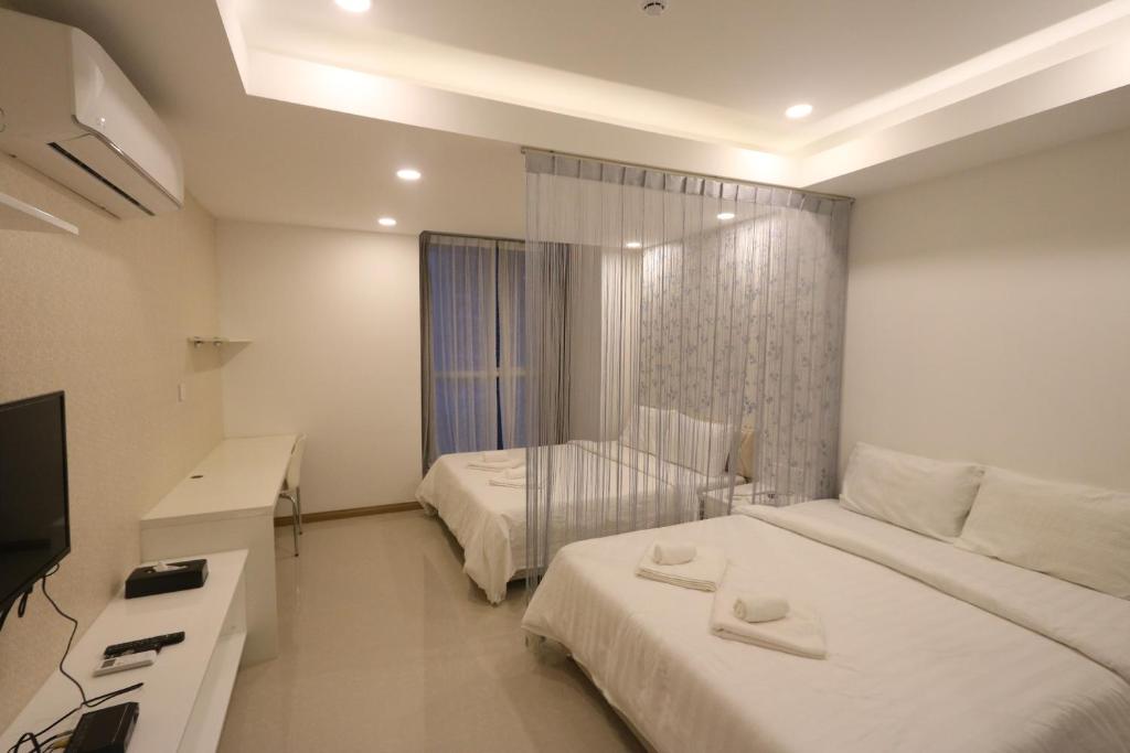 Postel nebo postele na pokoji v ubytování CA&SA Serviced Apartment