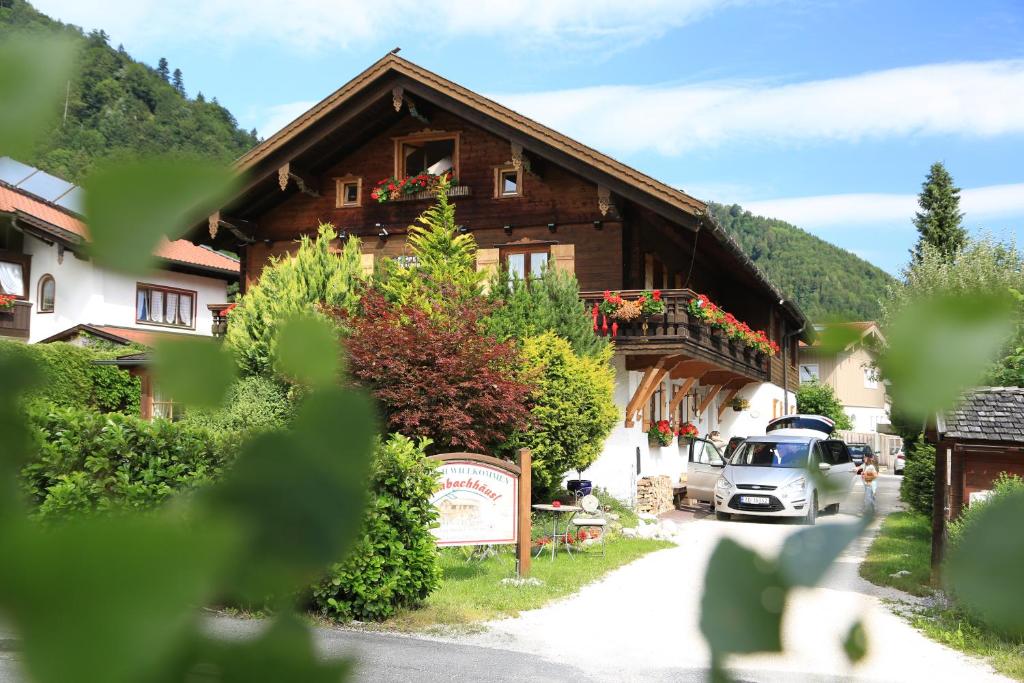 a house with a car parked in front of it at Hotel Garni Landhaus Traunbachhäusl in Ruhpolding