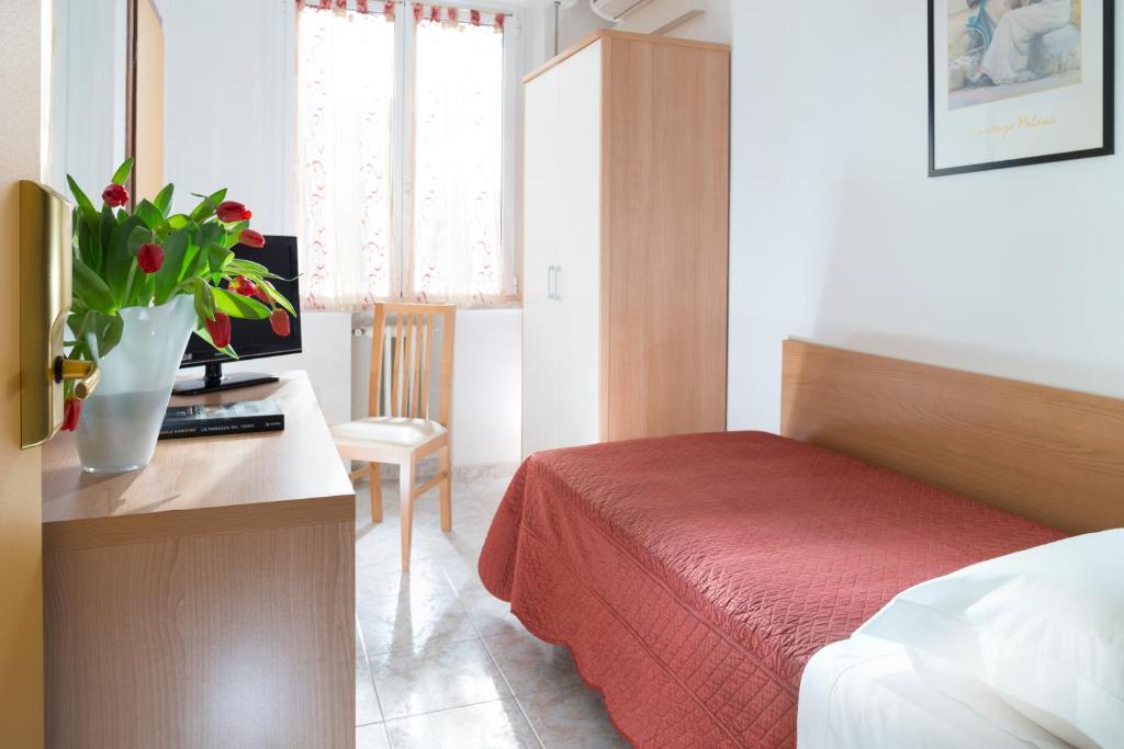 Postel nebo postele na pokoji v ubytování Hotel Bellerofonte