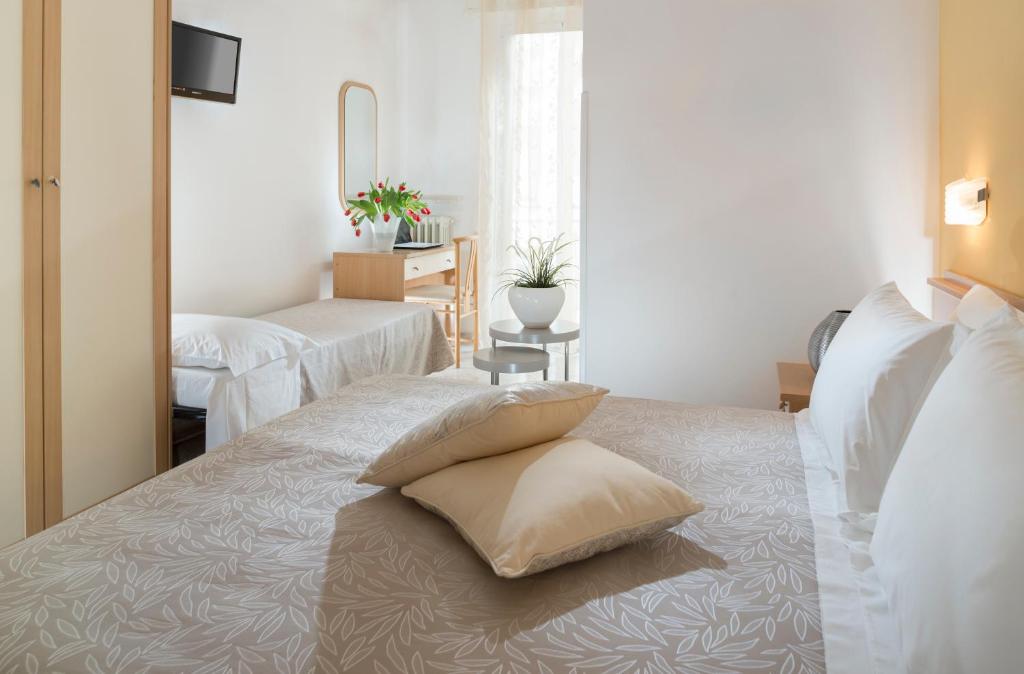 Postel nebo postele na pokoji v ubytování Hotel Bellerofonte