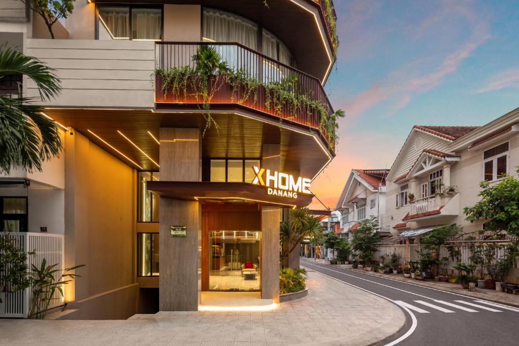 a building with a sign for a home clinic at XHOME Danang Hotel & Suite - Near My Khe Beach in Danang