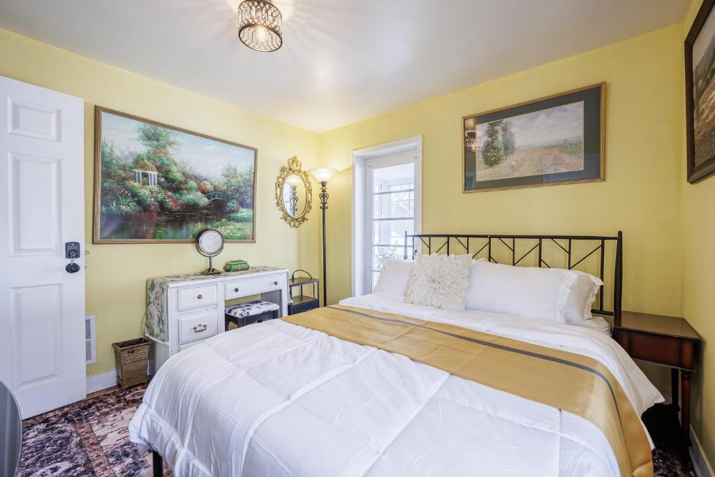 a bedroom with a white bed and a window at Room B3 Shared bathroom queen bed privacy balcony in Rochester