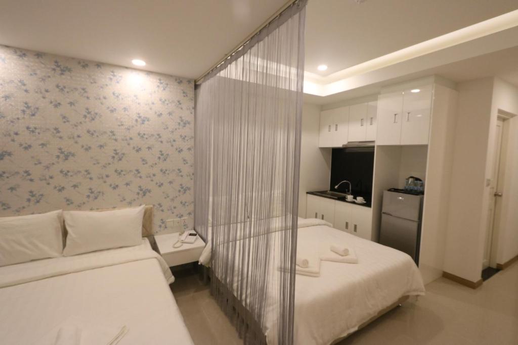 Postel nebo postele na pokoji v ubytování CA&SA Serviced Apartment