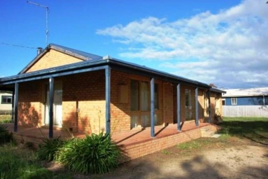 a brick house with windows on the side of it at Seaside Haven in Port Welshpool