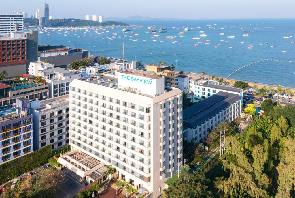 an aerial view of a large white building next to the water at The Bayview Hotel Pattaya in Pattaya