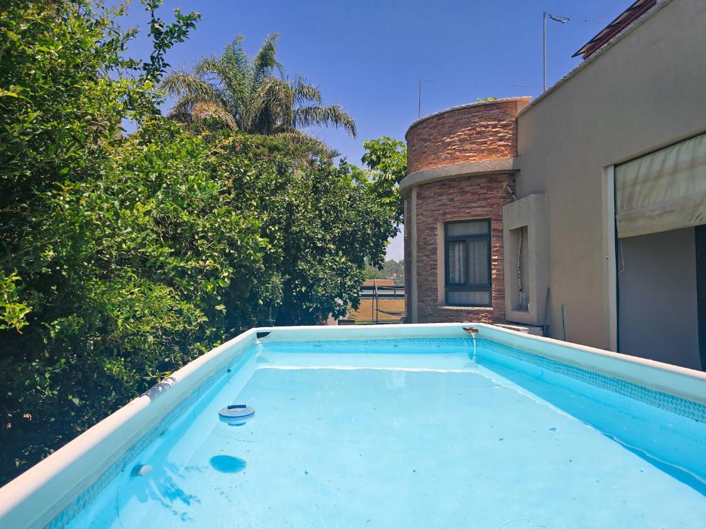 a swimming pool in the backyard of a house at Assaf's place - המקום של אסף in Aẖihud