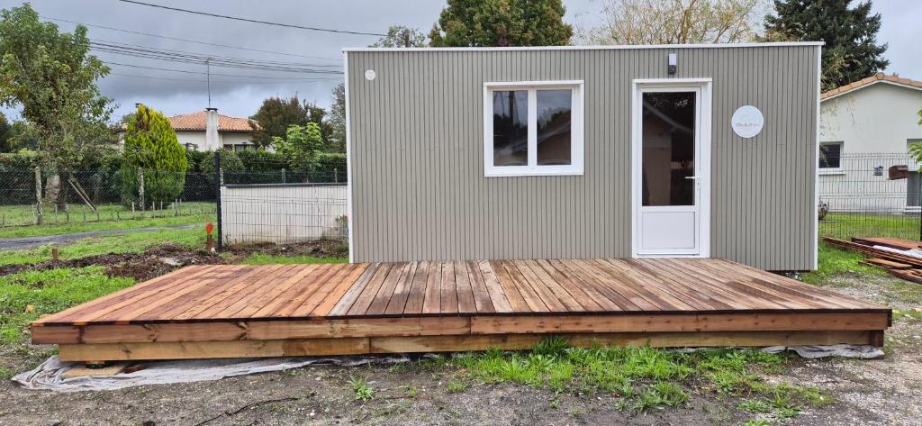 a tiny house sitting on a wooden deck at Modulbois studio castelnau in Castelnau-de-Médoc