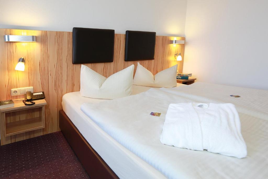 Postel nebo postele na pokoji v ubytování Hotel Promenade