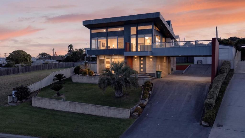 a large house with a lot of windows at Nautilus - Modern Lakeside Escape in Lakes Entrance