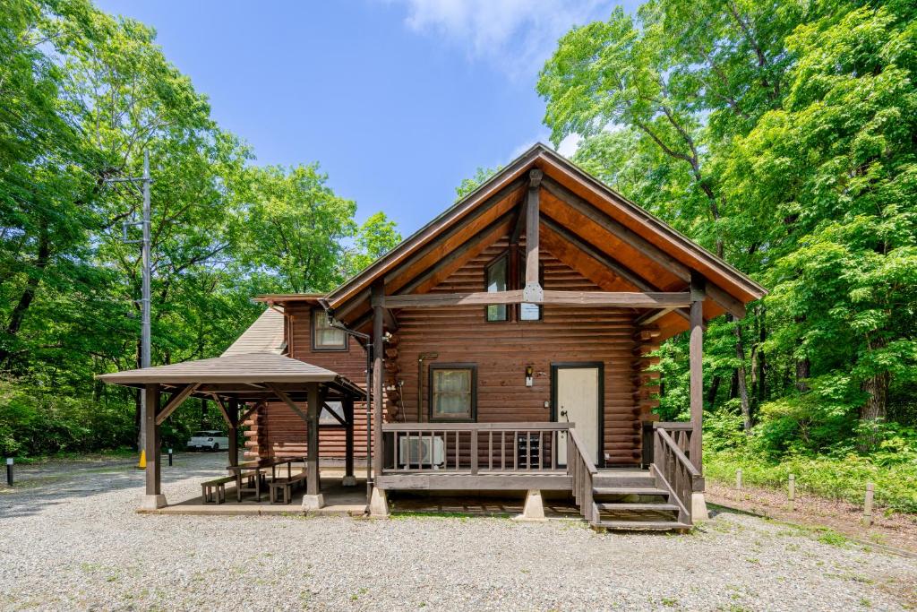a log cabin with a porch and a gazebo at COTTAGE SaY in Nasushiobara