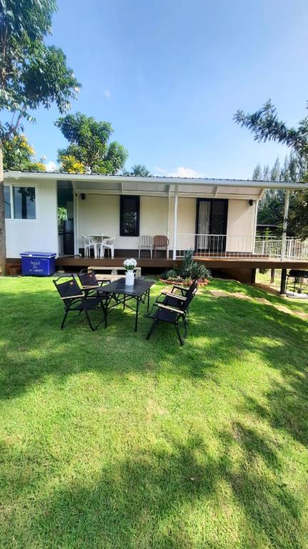 a house with a table and chairs in the yard at Honeymoon in Pong Talong