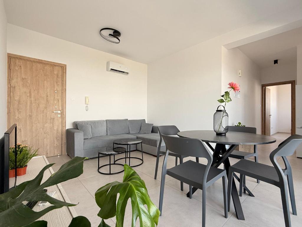 a living room with a couch and a table and chairs at Esmee In, Engomi in İncirli