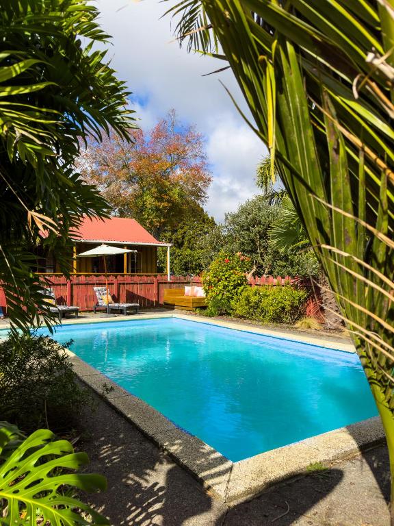 a swimming pool in a yard with a house at Relax a Lodge in Kerikeri