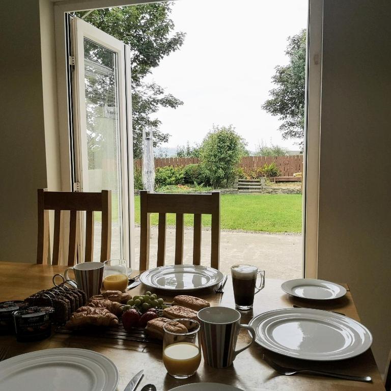 a table with plates of food on it with a window at Letterkenny View in Letterkenny