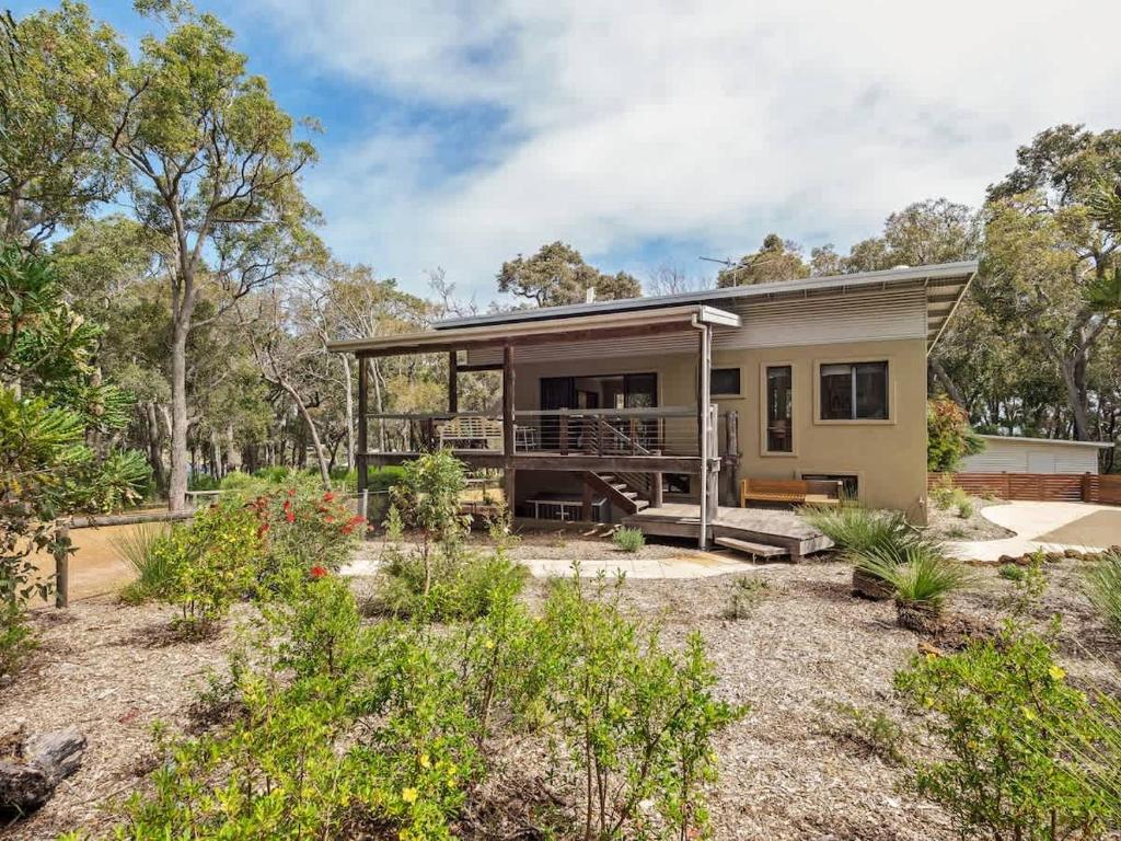a small house with a porch and a balcony at Rosella - Secluded Bushland Escape with Valley Views in Yallingup
