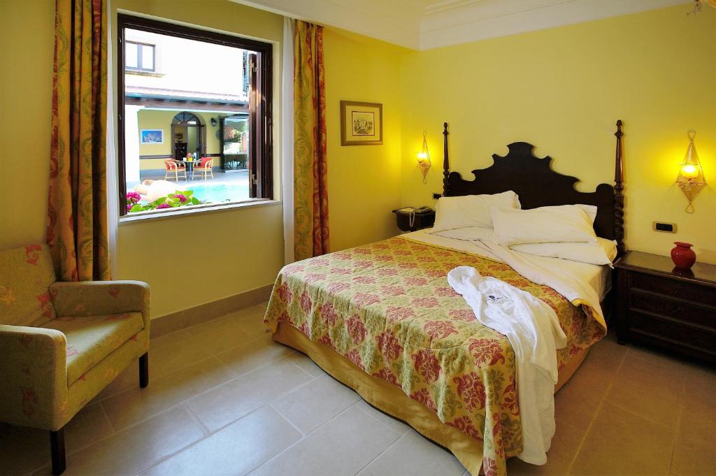 Postel nebo postele na pokoji v ubytování Arciduca Grand Hotel