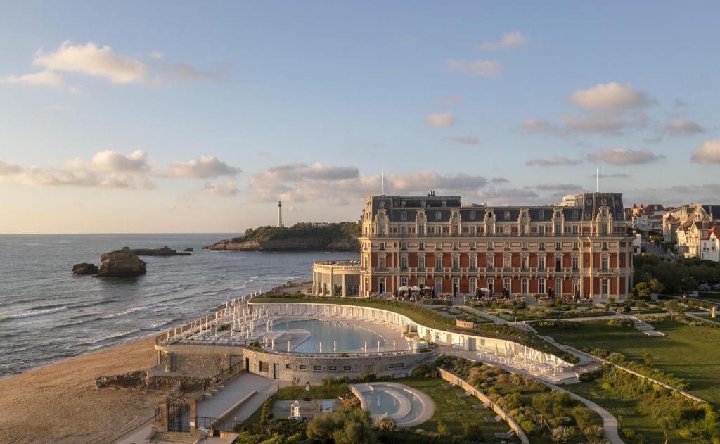 a view of a building next to the water at Hôtel du Palais Biarritz, in The Unbound Collection by Hyatt in Biarritz