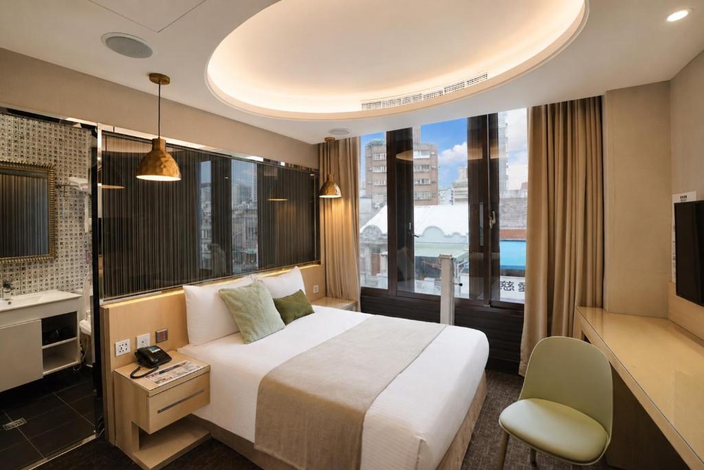 a hotel room with a bed and a large window at V-one Hotel - Ningxia No. 2 Inn in Taipei