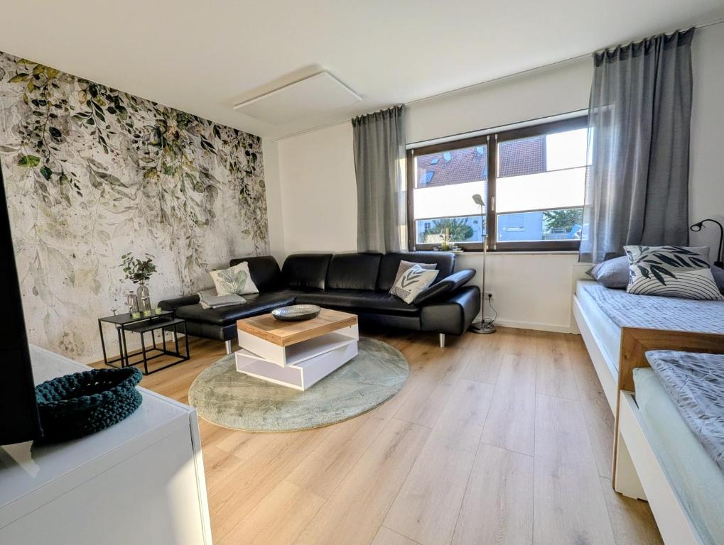 a living room with a couch and a table at Main Ferienwohnung Erlabrunn in Erlabrunn
