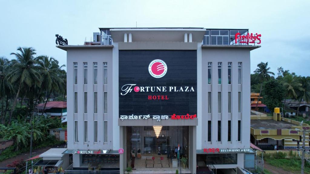 a building with a sign on the side of it at Fortune Plaza Hotel in Udupi