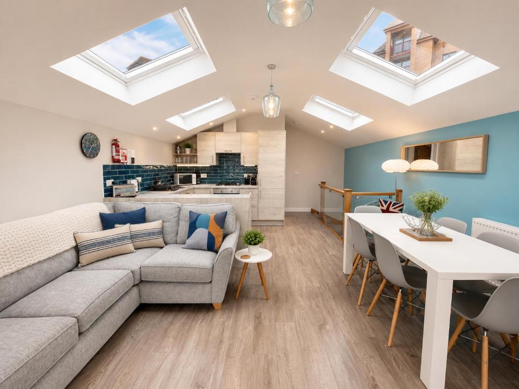 a living room with a couch and a table at Seaside Escape in Westward Ho! 3-Bed Family Holiday Home with Sea Views in Westward Ho