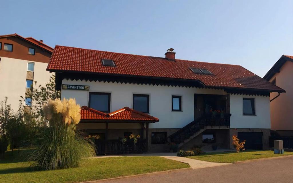 a large white house with a red roof at Apartment CDR in Zreče