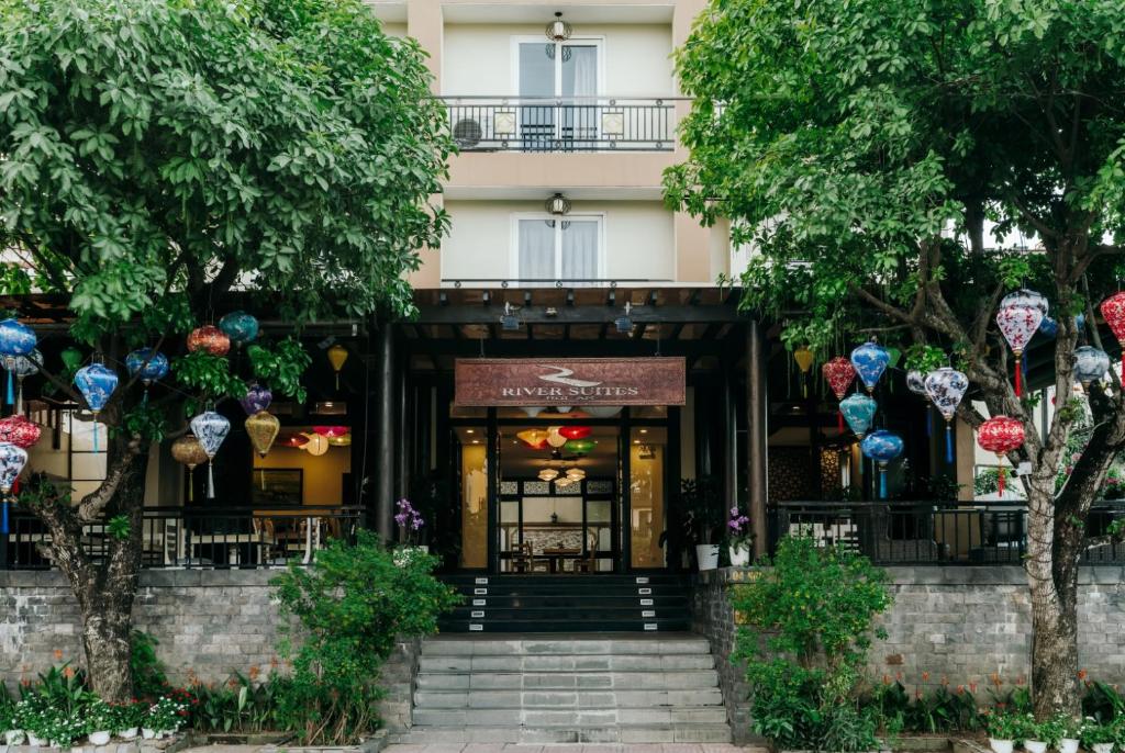 a building with a staircase in front of it at River Suites Hoi An in Hoi An
