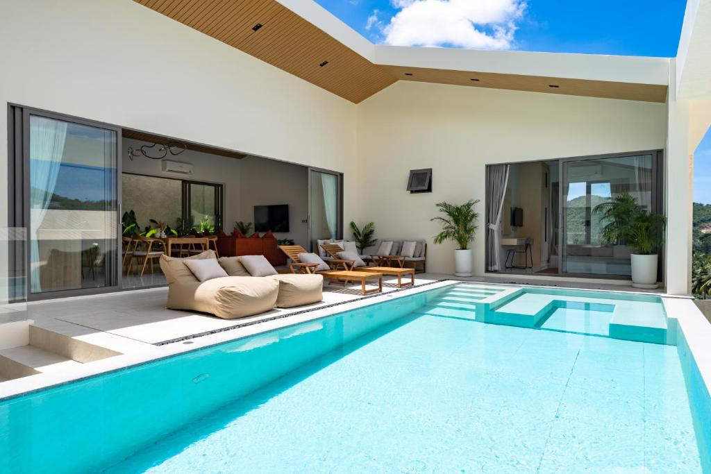 a swimming pool in a house with a living room at Modern Jungle Pool Villa in Mae Nam