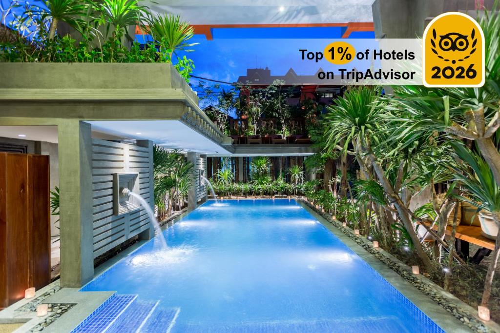 a swimming pool with a waterfall in a building at Golden Temple Boutique in Siem Reap