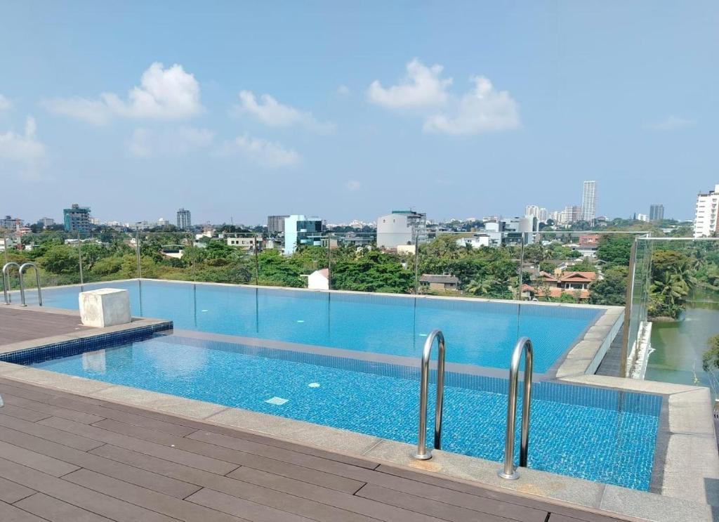 a swimming pool on the roof of a building at Water Park Suites in Nugegoda