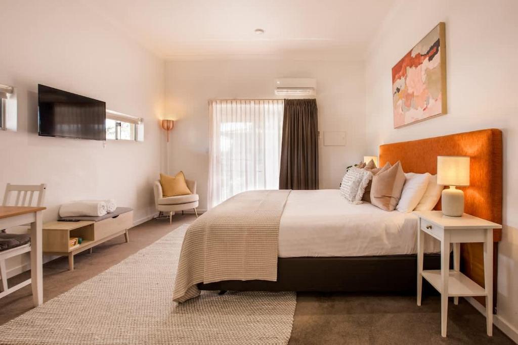 a bedroom with a bed and a table and a chair at Lana Unit 31 Studio Apartment - Central Base for South West Adventures in Margaret River Town