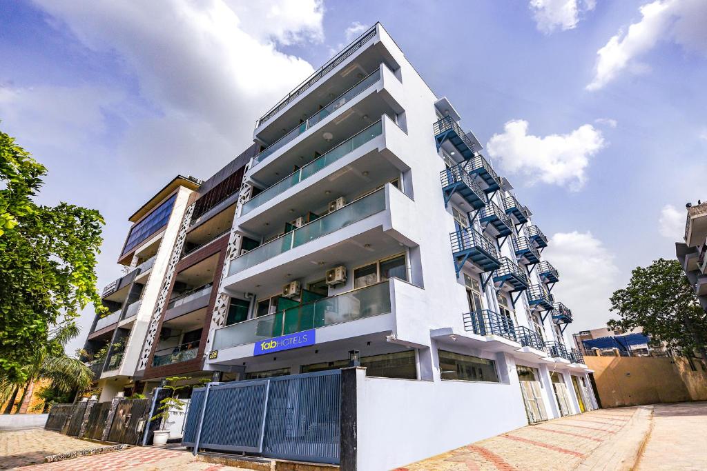 a white building with balconies on a street at FabHotel The Silken Stay in Gurgaon