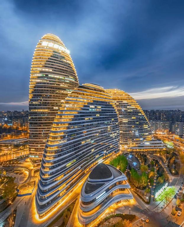 a large building in a city at night at Atour Hotel Wangjing SOHO in Beijing