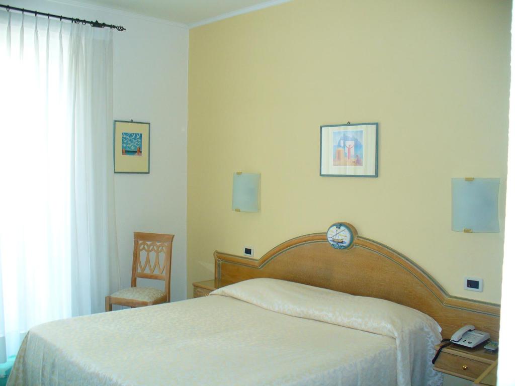 Postel nebo postele na pokoji v ubytování Hotel La Marticana